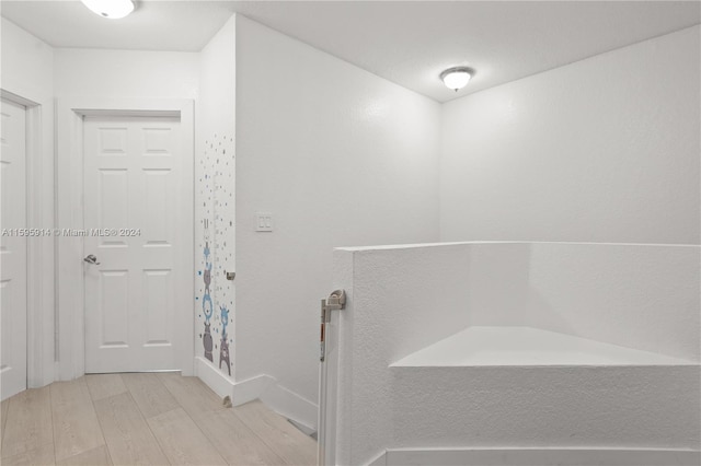 bathroom featuring wood-type flooring and walk in shower