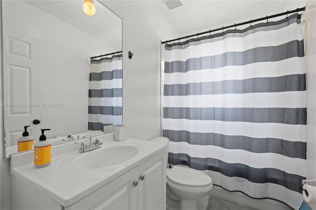 bathroom featuring vanity, toilet, and a shower with shower curtain