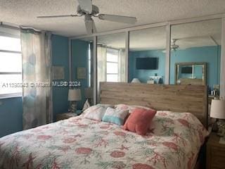 bedroom featuring a closet, a textured ceiling, and ceiling fan