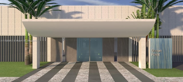 view of parking with fence and a gate