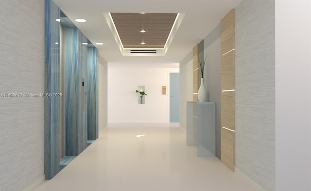 hall with recessed lighting, a raised ceiling, and tile patterned flooring