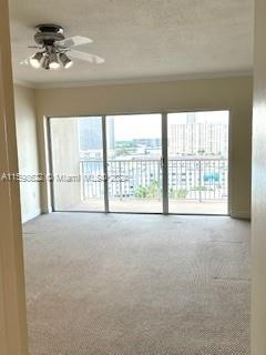 spare room with ceiling fan, carpet floors, and ornamental molding