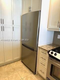 kitchen featuring appliances with stainless steel finishes, light countertops, and light tile patterned floors