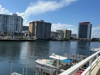 dock area with a city view and a water view