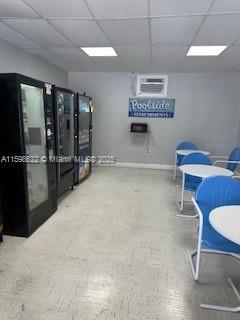 interior space with a drop ceiling and baseboards
