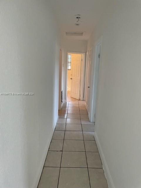 hall with light tile patterned floors