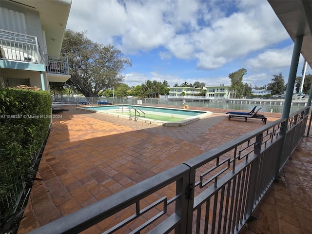 view of swimming pool with a patio area