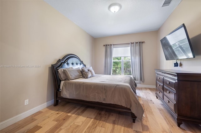 bedroom with light hardwood / wood-style flooring