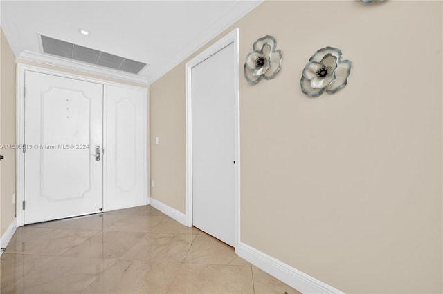 foyer featuring ornamental molding