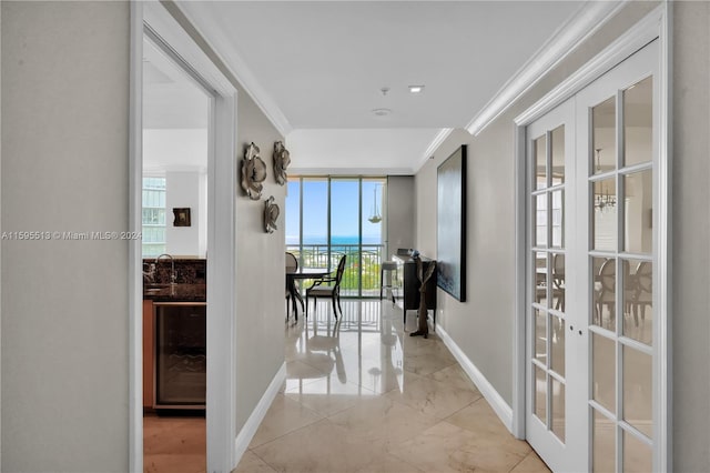 hall featuring plenty of natural light, sink, crown molding, and french doors