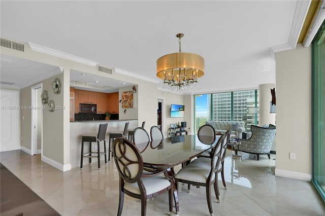 dining space with a chandelier and crown molding