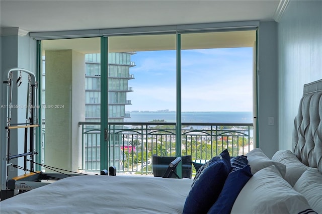 bedroom with a water view, multiple windows, and crown molding