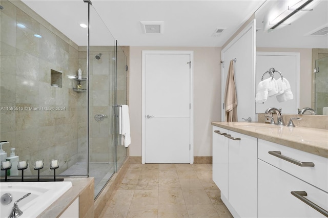 bathroom featuring vanity, tile patterned floors, and an enclosed shower