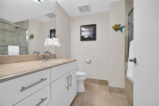 bathroom featuring tile patterned floors, vanity, walk in shower, and toilet