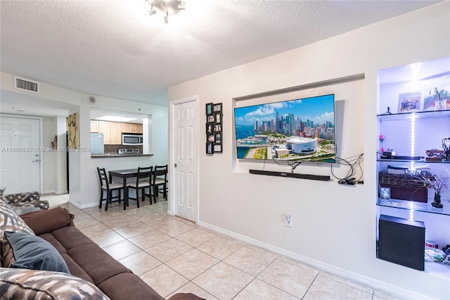 living room featuring light tile floors and a textured ceiling