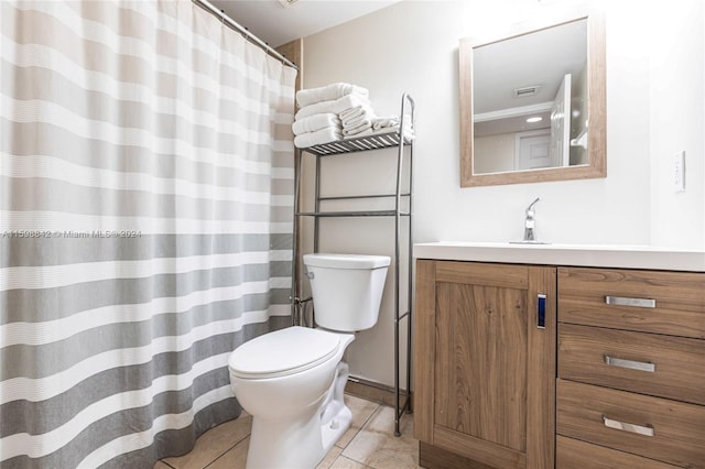 bathroom with tile flooring, vanity, and toilet