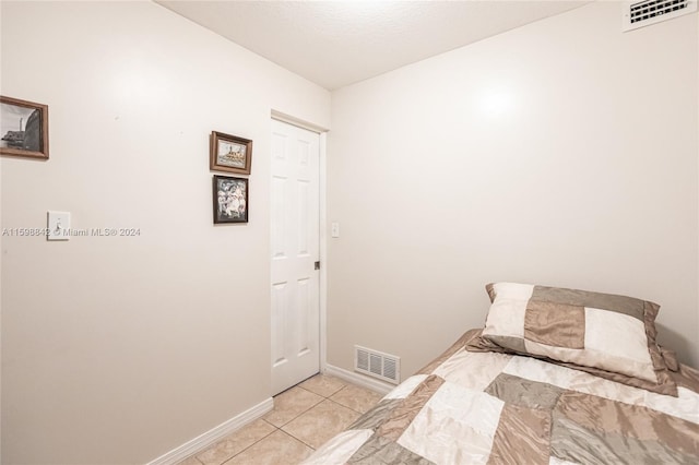 unfurnished bedroom featuring light tile floors