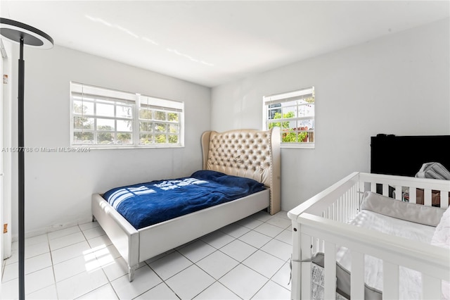 bedroom with multiple windows and light tile floors