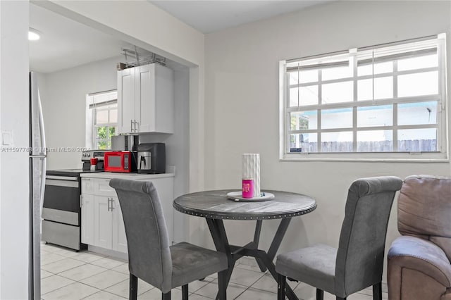 dining space featuring light tile floors