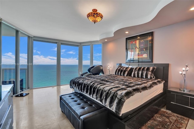 tiled bedroom featuring access to exterior, recessed lighting, floor to ceiling windows, and a water view