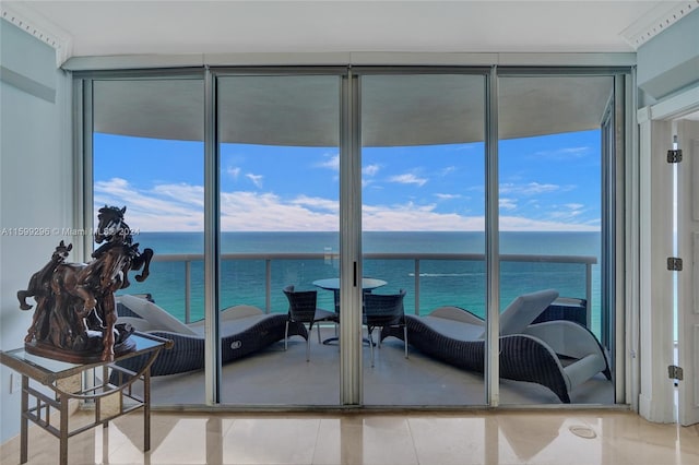 interior space featuring a wall of windows, a water view, and light tile patterned flooring