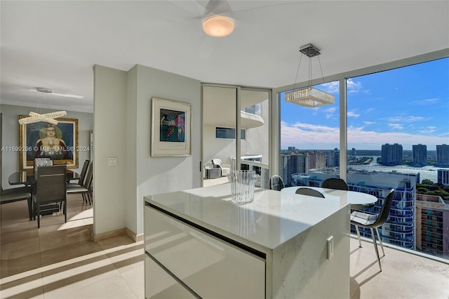 kitchen featuring crown molding, pendant lighting, floor to ceiling windows, and a kitchen island