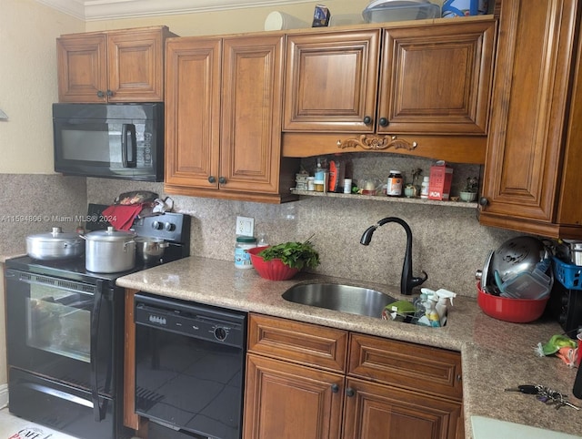 kitchen featuring sink, crown molding, tasteful backsplash, and black appliances