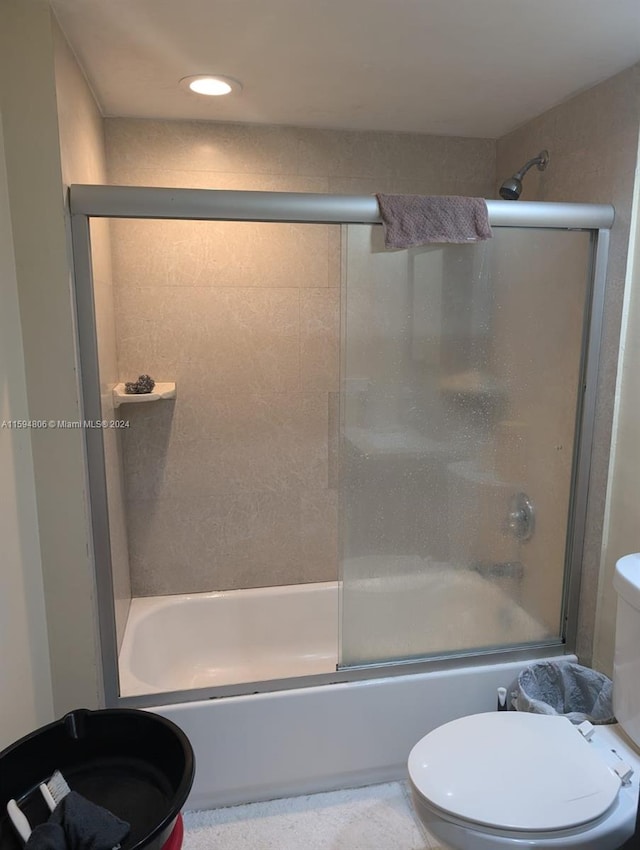 bathroom with toilet, bath / shower combo with glass door, and recessed lighting