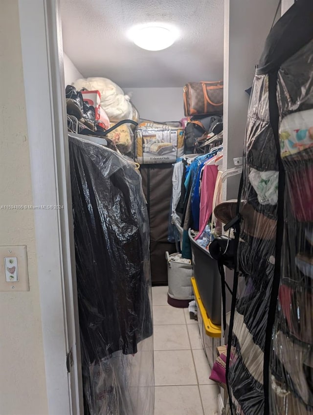 spacious closet featuring light tile floors