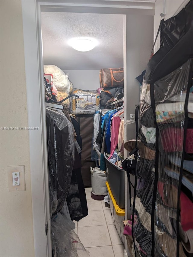 spacious closet with light tile floors