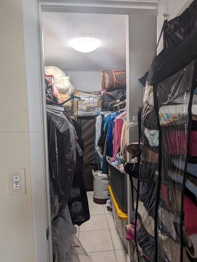 walk in closet with tile patterned floors