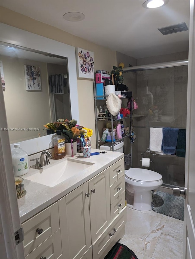 bathroom featuring vanity, toilet, and tile floors