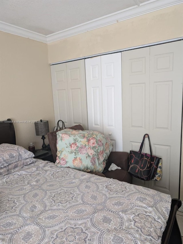 bedroom featuring a closet and ornamental molding