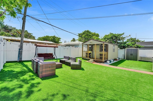 view of yard featuring outdoor lounge area and a storage unit