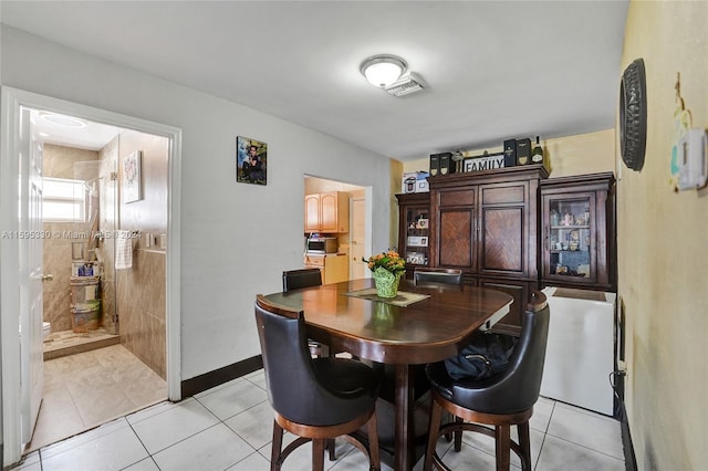 dining area featuring light tile patterned flooring