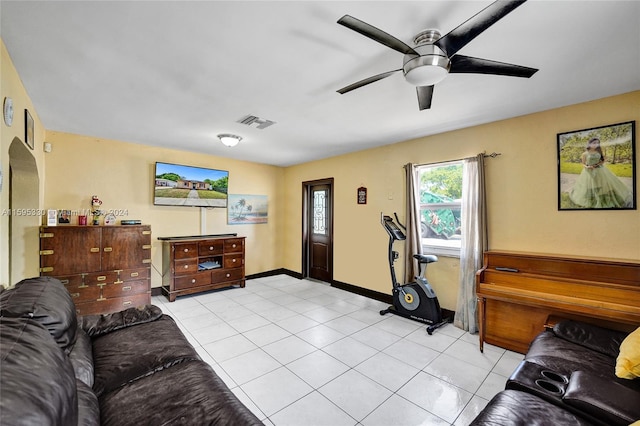 tiled living room featuring ceiling fan