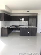 kitchen featuring light countertops and freestanding refrigerator