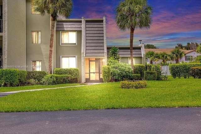 view of front of property with a lawn