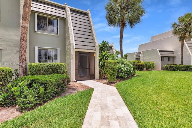 property entrance featuring a lawn