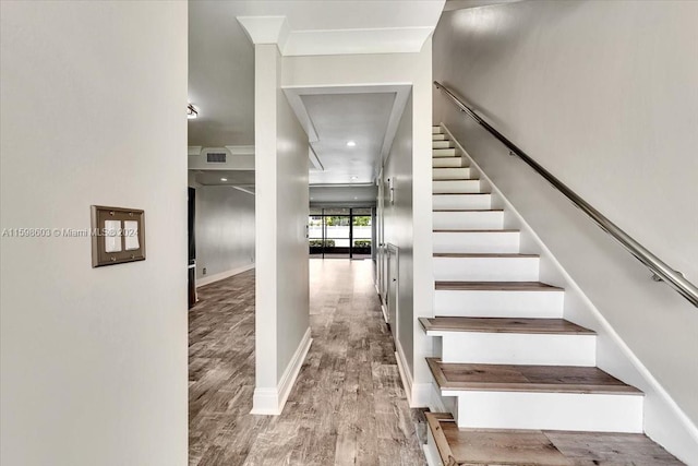 stairs featuring hardwood / wood-style flooring