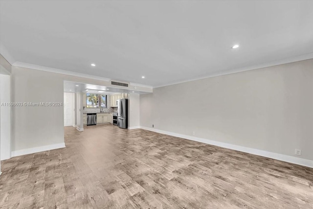 unfurnished living room featuring light hardwood / wood-style floors and ornamental molding