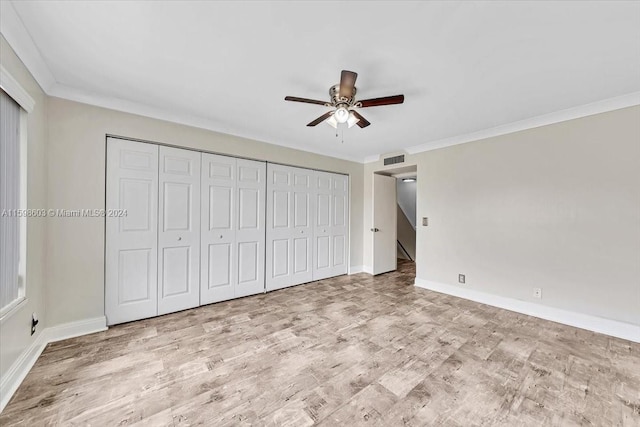 unfurnished bedroom with ceiling fan, light wood-type flooring, and crown molding