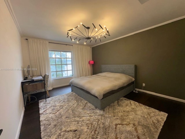 bedroom featuring crown molding, dark hardwood / wood-style floors, and a notable chandelier