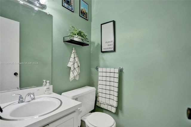 bathroom featuring toilet and vanity