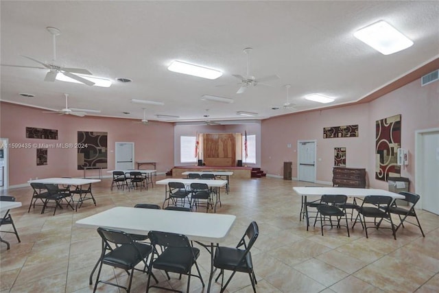 tiled dining room with ceiling fan and a textured ceiling