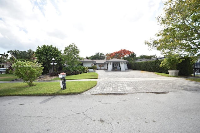 ranch-style house with a front lawn