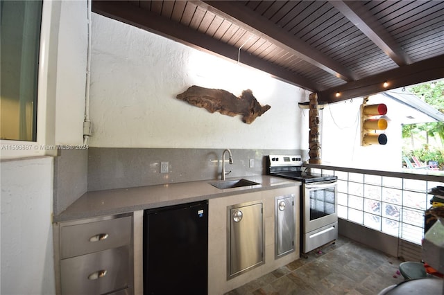 kitchen with refrigerator, stainless steel range with electric stovetop, decorative backsplash, beam ceiling, and sink