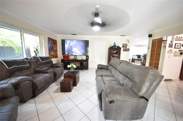 tiled living room with ceiling fan and ornamental molding