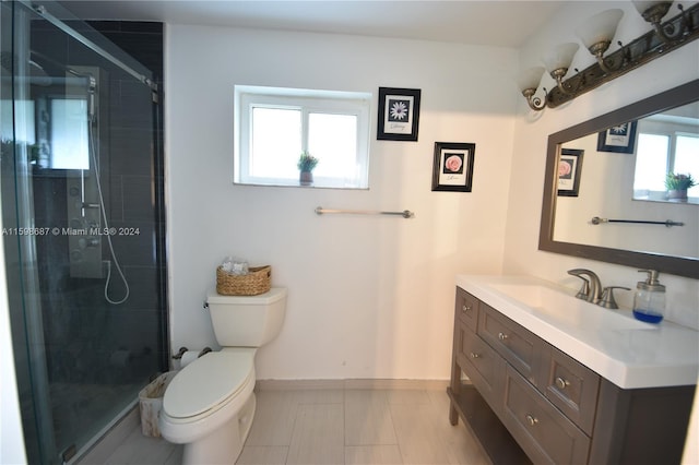 bathroom with toilet, an enclosed shower, and vanity