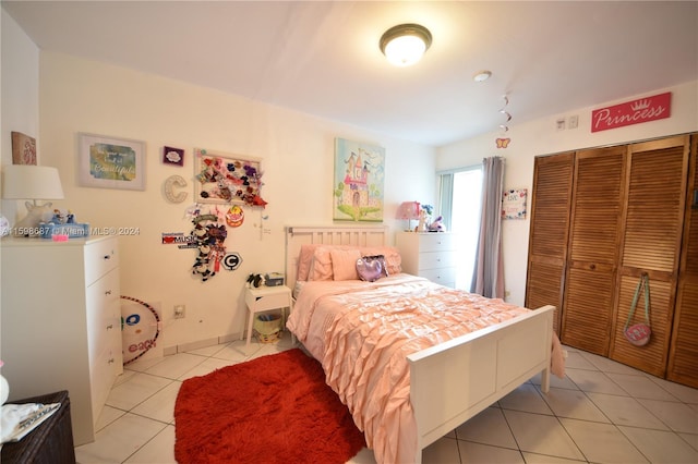 bedroom featuring a closet and light tile patterned floors